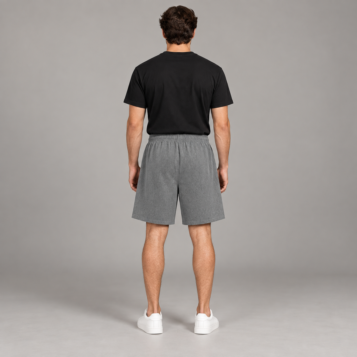 Model wearing the grey Loose Fit Elastic Waist Shorts, back view