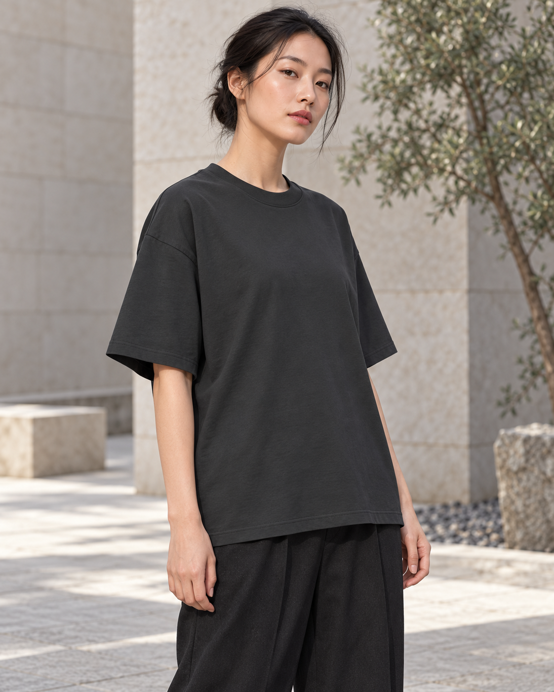 Model wearing the black Classic Loose Boxy Tee, front view