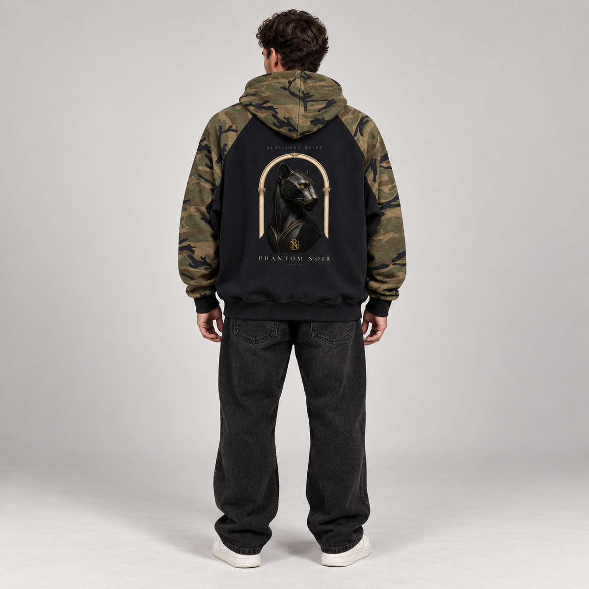 AI styling mockup: male model back view wearing Belvedere Noire Phantom Noir camo hoodie
