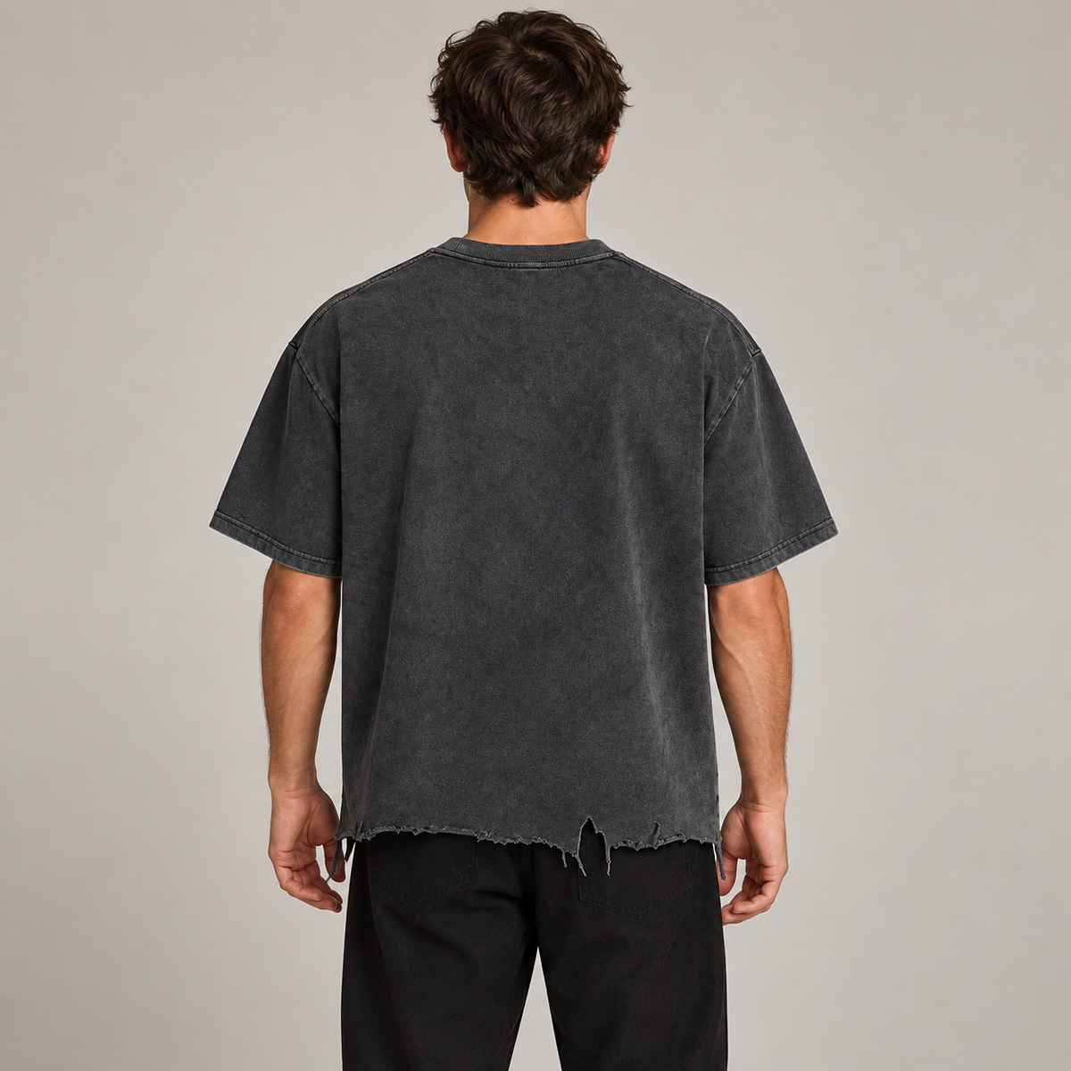 Model wearing the charcoal Vintage Wash Distressed Hem T-Shirt, back view