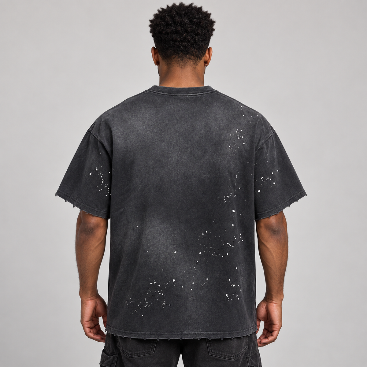 AI styling mockup: male model back view wearing Belvedere Noire paint splatter T-shirt