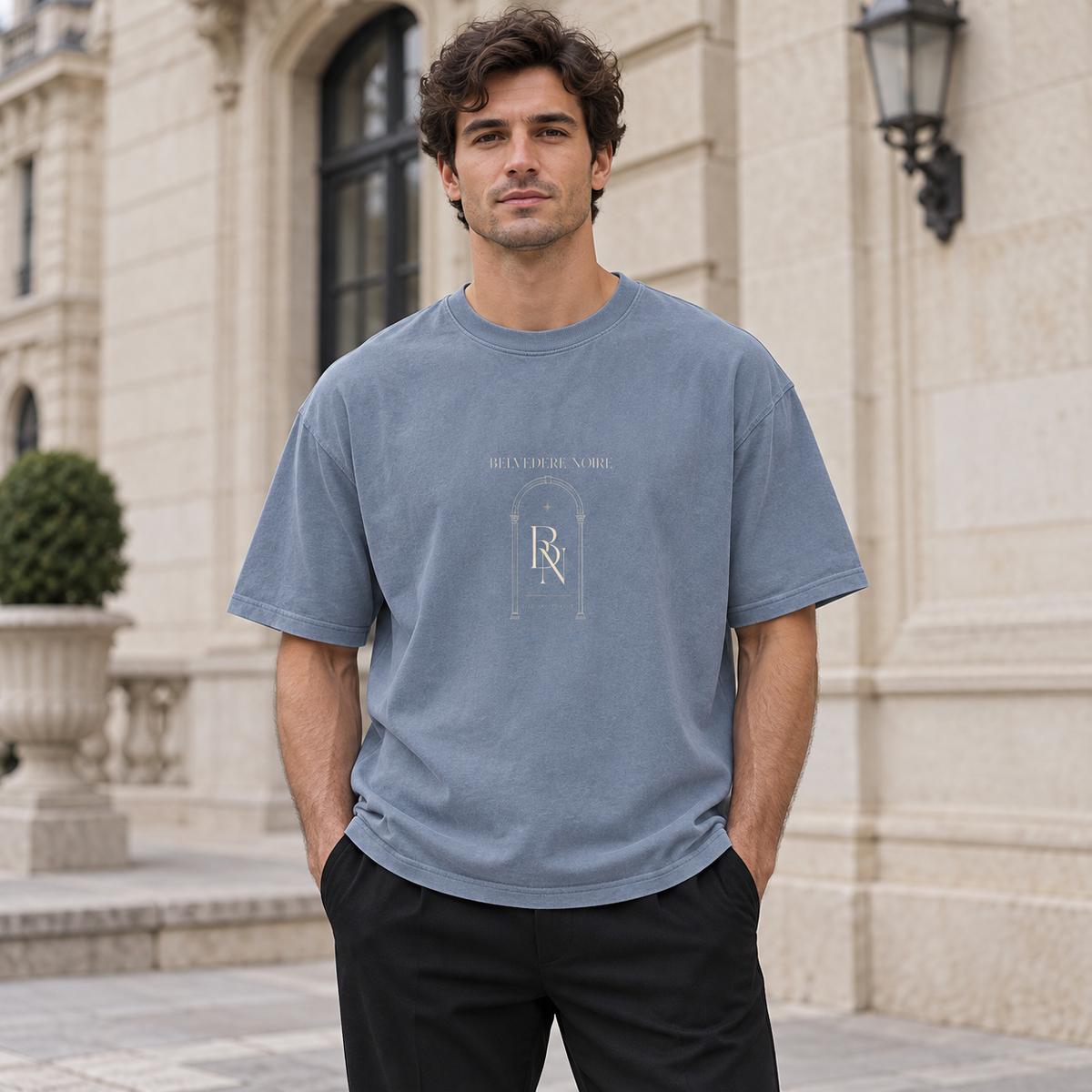 Model wearing the blue Enzyme Washed Oversized T-Shirt outdoors